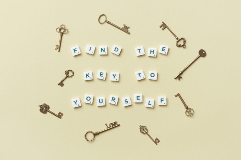 Creative arrangement of vintage keys and motivational text 'Find the key to yourself'.