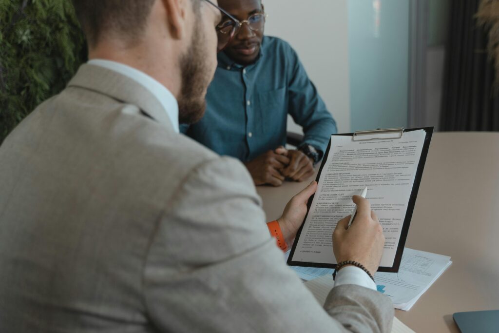 pexels-photo-5439449-5439449 A recruiter reviews a candidate's documents during a job interview in a modern office setting.